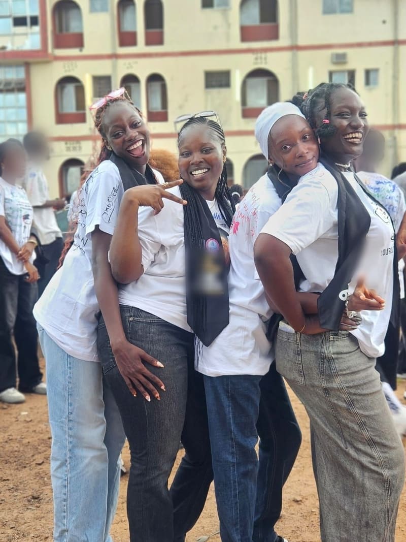 Four friends laughing together on sign-out day
